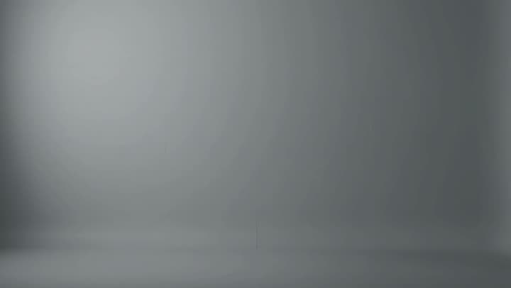 a slow push in on an empty grey studio wall